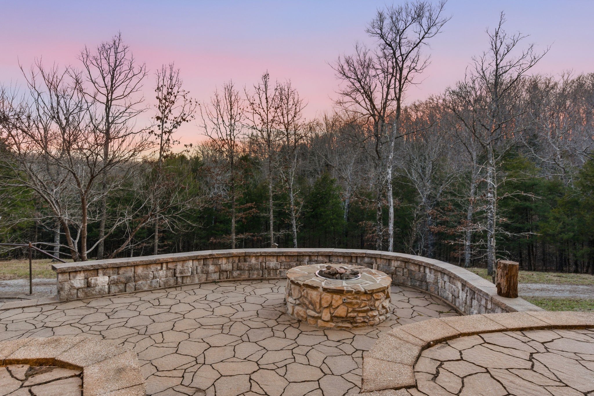 Stone fire pit and patio at dusk