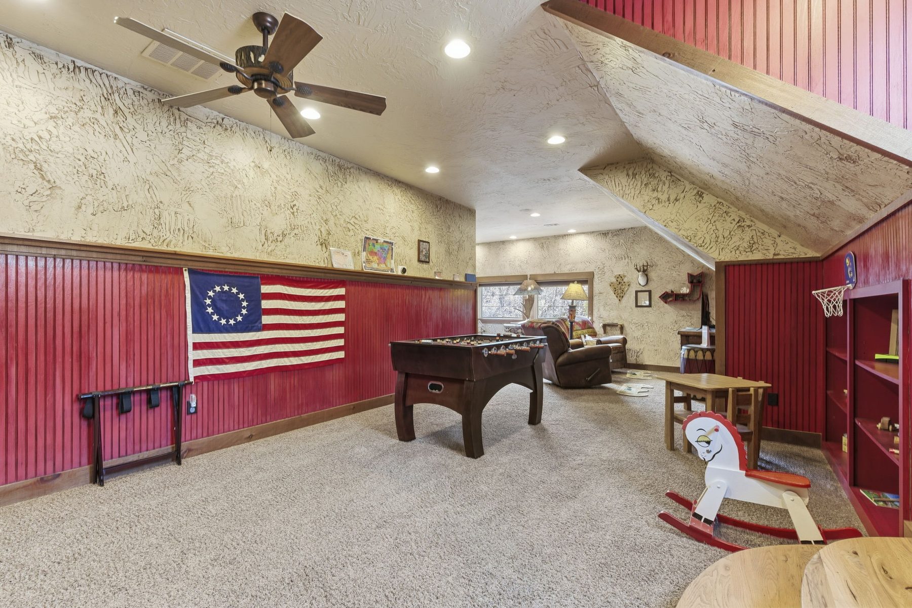 Rec room with foosball table and flag wall