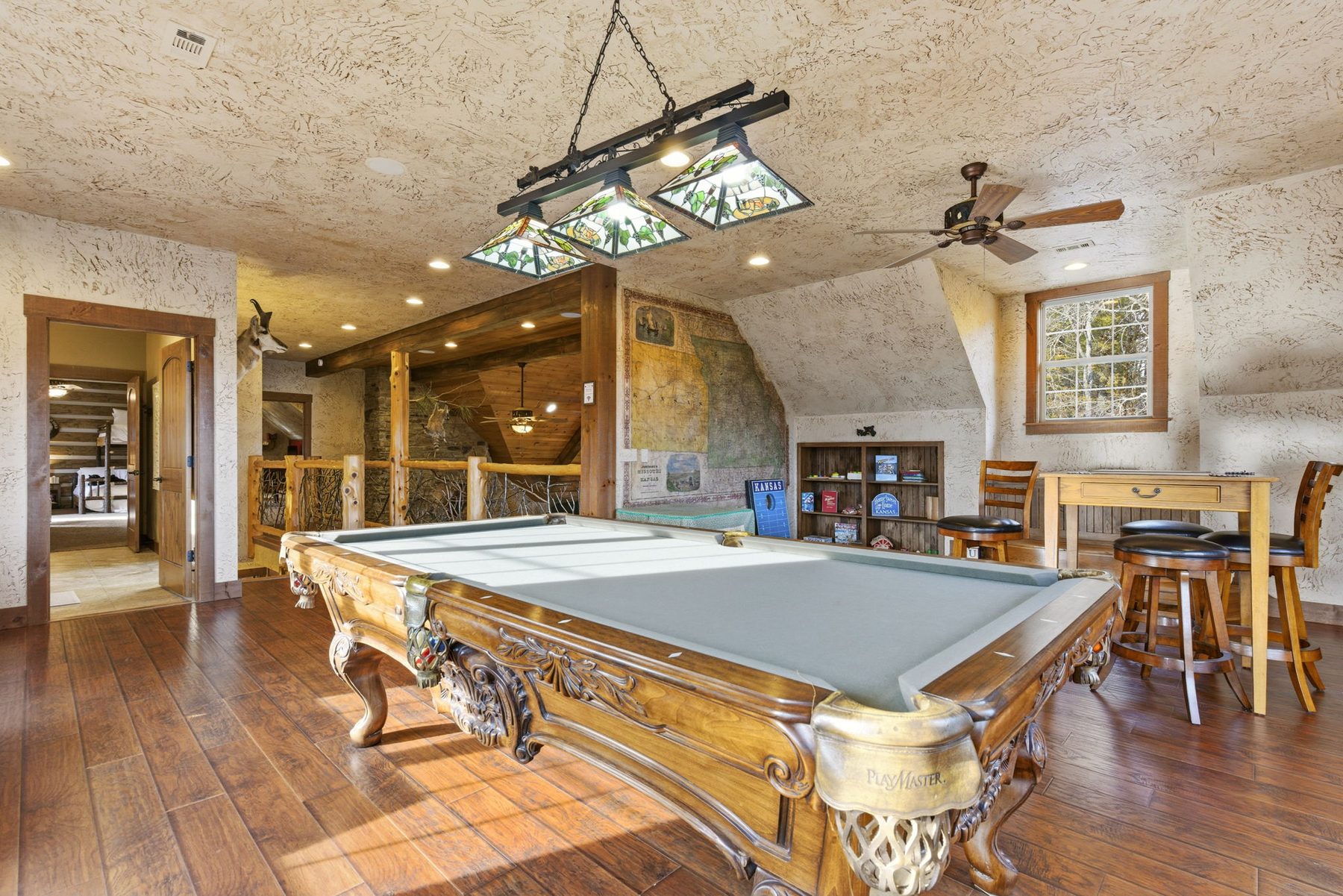 Upstairs game room with pool table and string lights